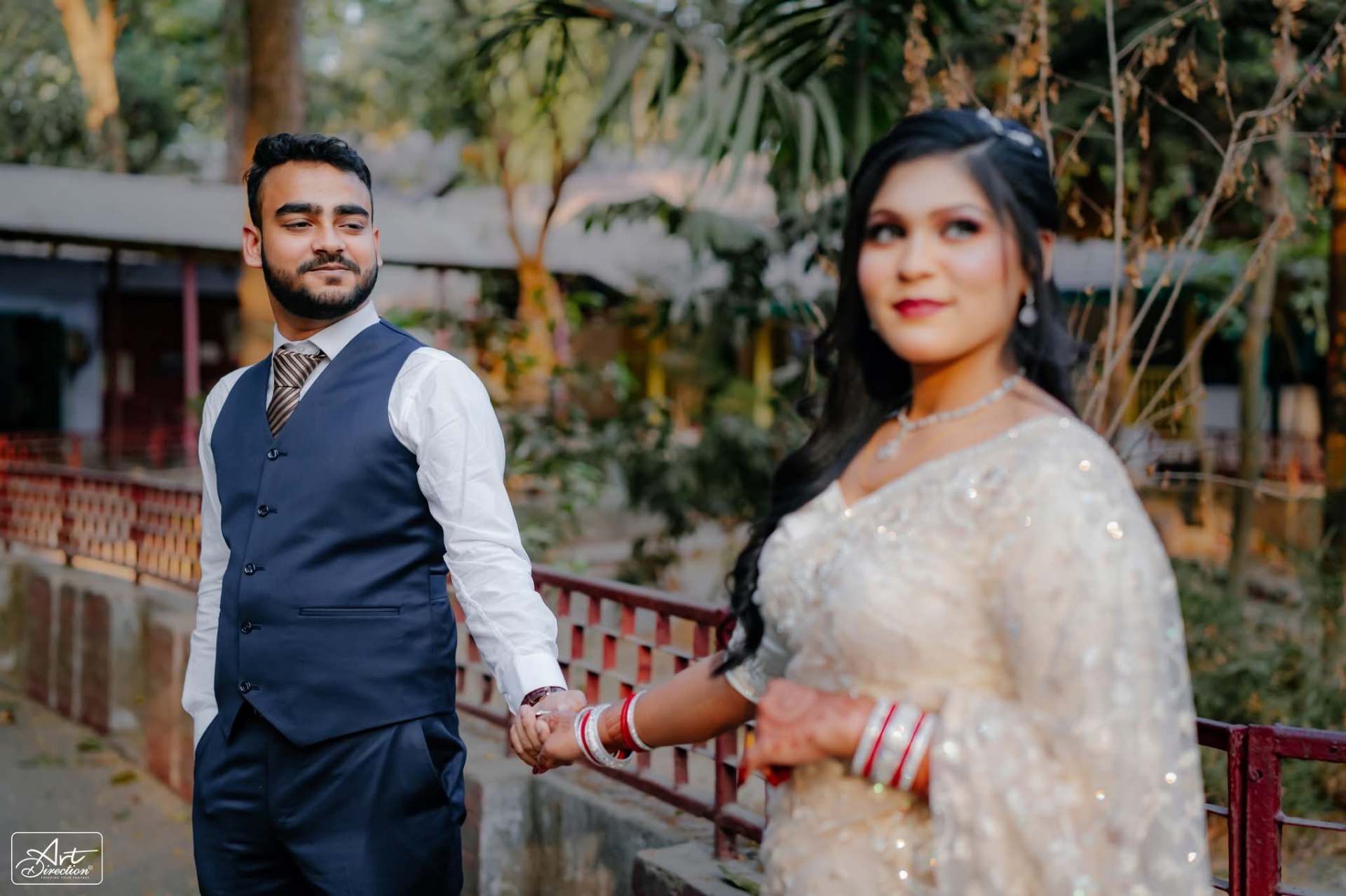 A couple holding hands by a railing